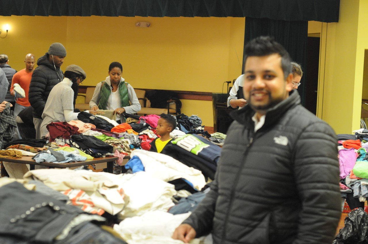 A volunteer helping at a community donation event